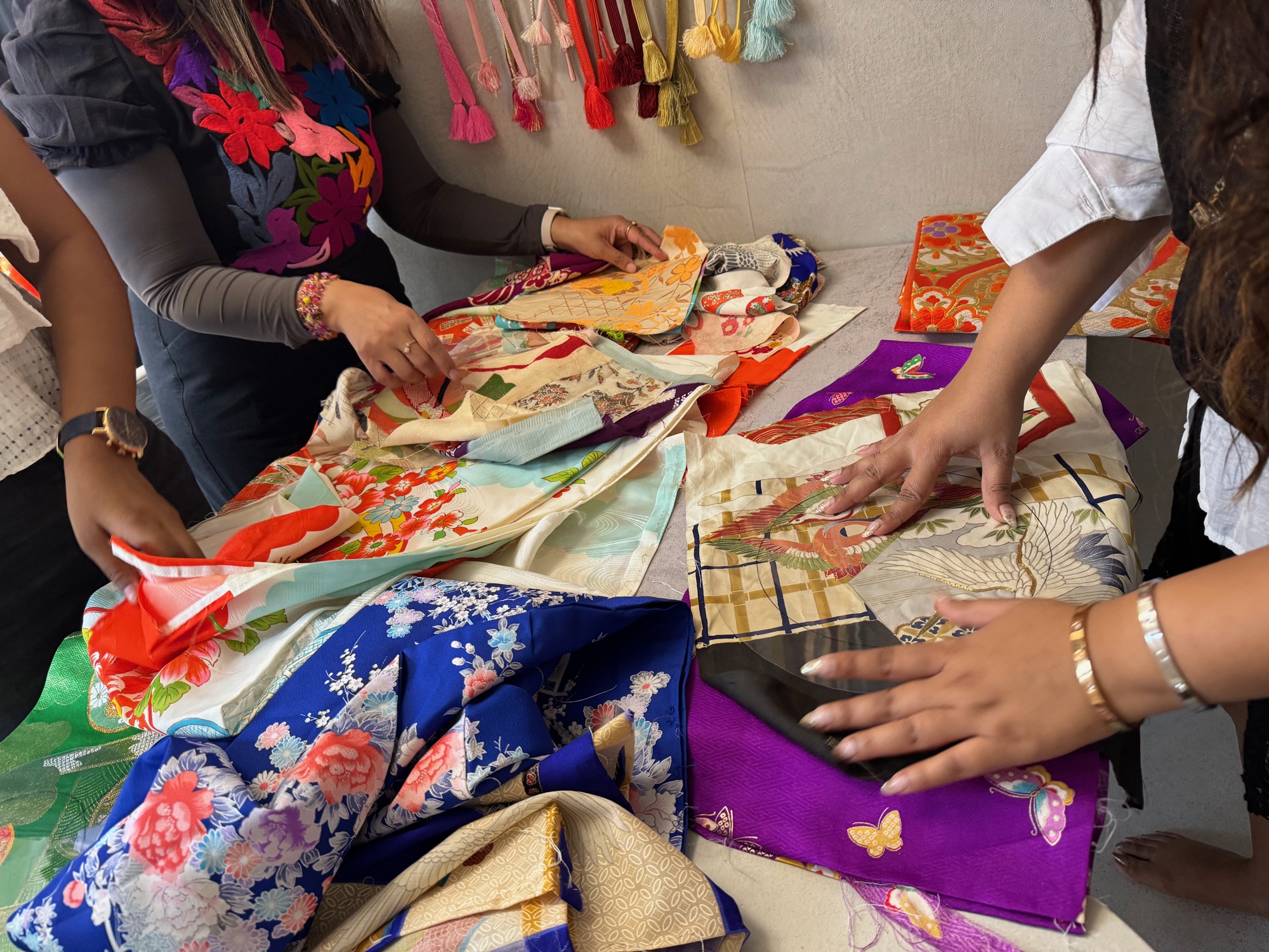 Guests exploring colorful kimono patterns together