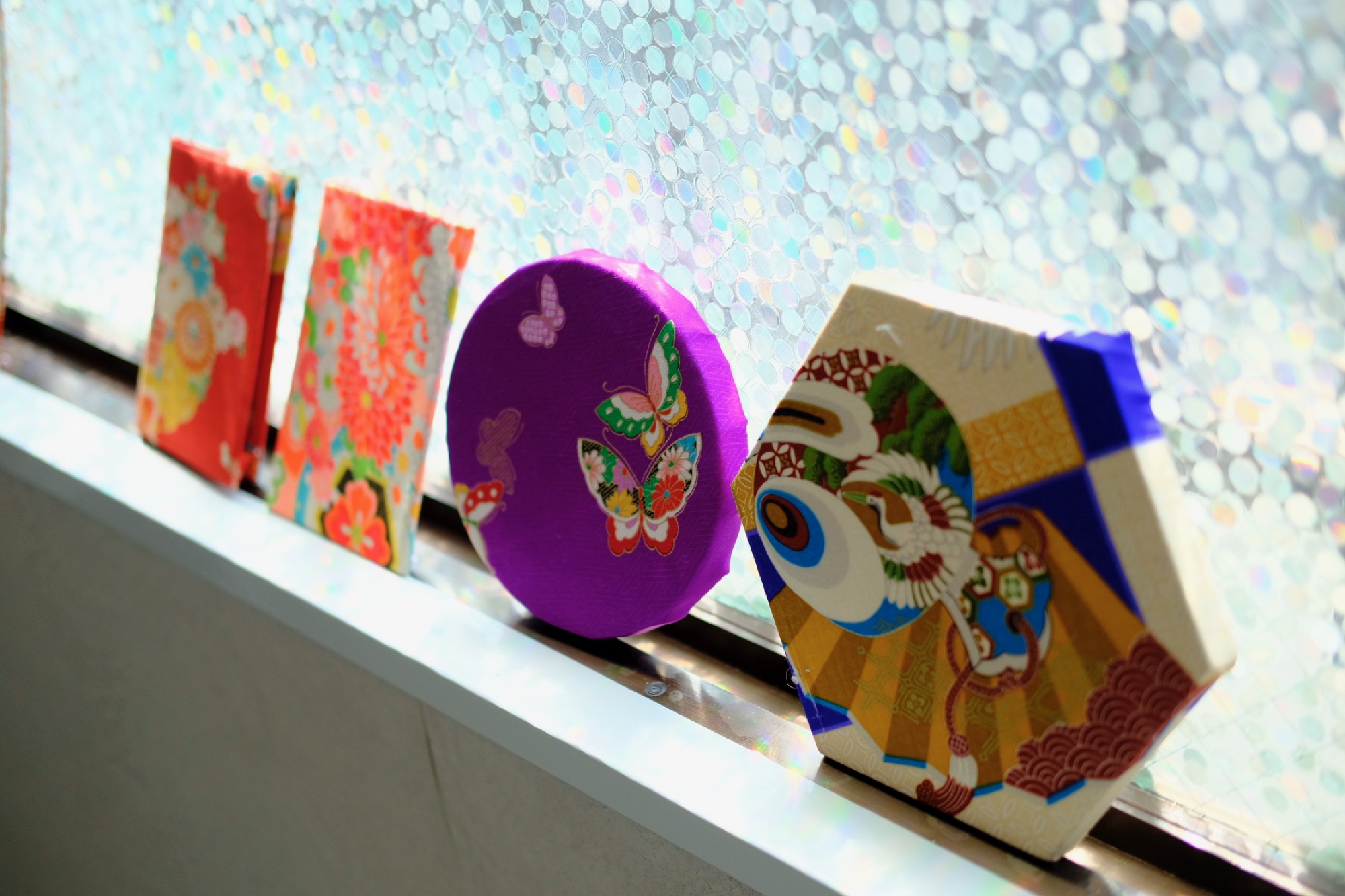 Finished kimono-covered creations displayed in the studio window