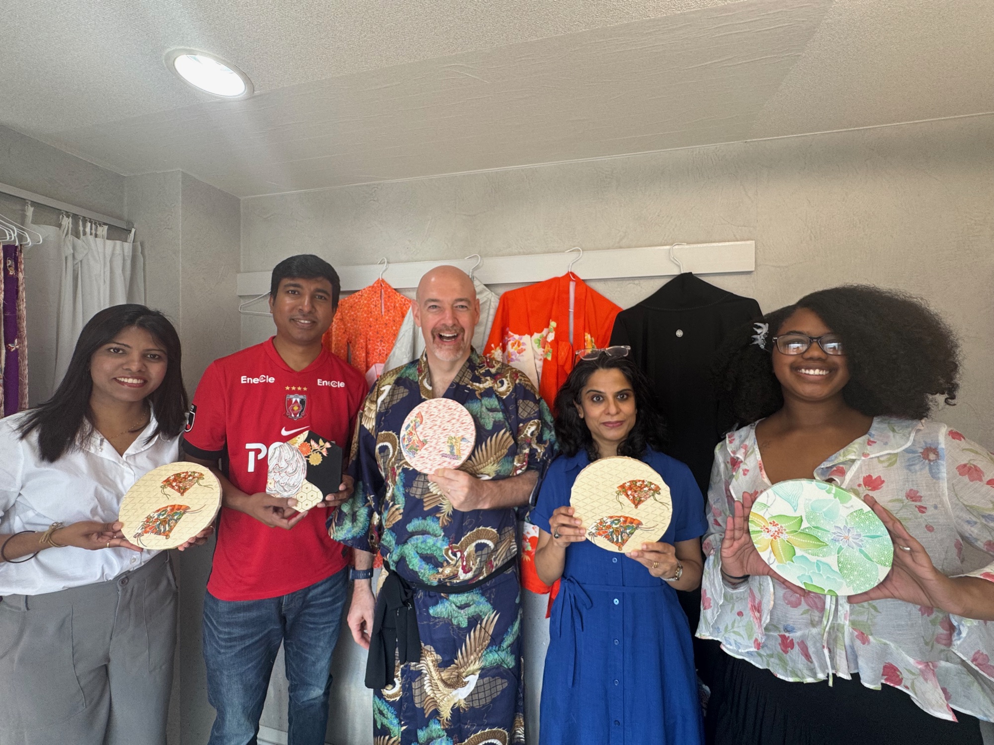 Workshop group holding their completed handmade kimono creations
